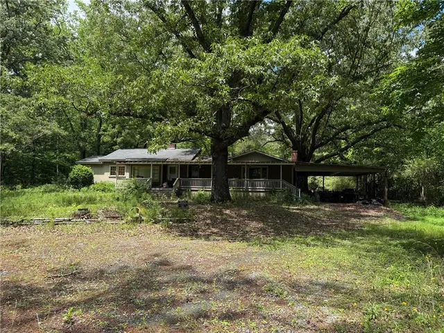 a backyard of a house with yard and outdoor seating
