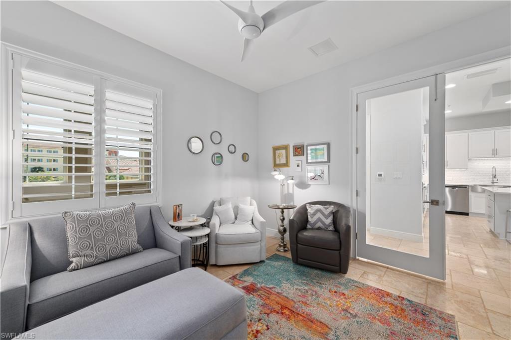 21490 Strada Nuova Circle, Unit D211 Estero, FL 33928 - Photo 14 of 45 a living room with furniture and a large window