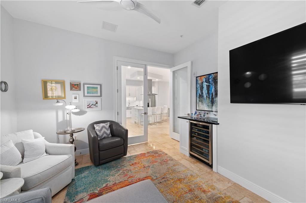 21490 Strada Nuova Circle, Unit D211 Estero, FL 33928 - Photo 16 of 45 a living room with furniture and a flat screen tv