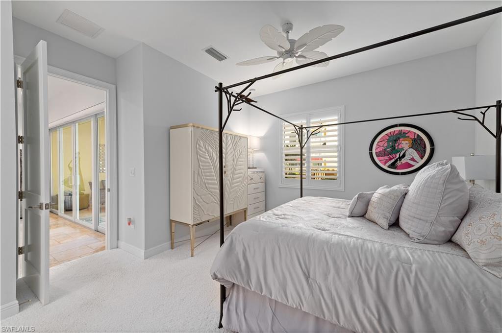 21490 Strada Nuova Circle, Unit D211 Estero, FL 33928 - Photo 18 of 45 a bedroom with a bed and a large mirror