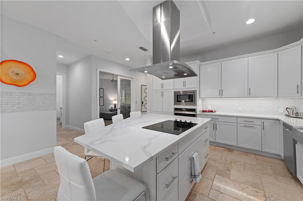 21490 Strada Nuova Circle, Unit D211 Estero, FL 33928 - Photo 2 of 45 a kitchen with stainless steel appliances granite countertop a sink a stove and a refrigerator