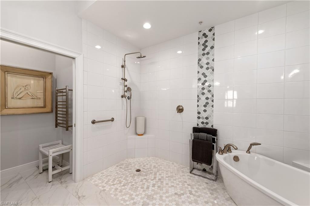 21490 Strada Nuova Circle, Unit D211 Estero, FL 33928 - Photo 22 of 45 a bathroom with a bathtub a toilet and a shower