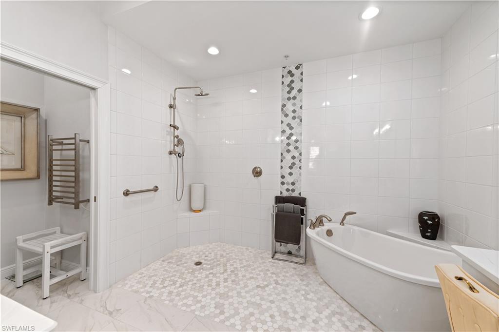 21490 Strada Nuova Circle, Unit D211 Estero, FL 33928 - Photo 25 of 45 a bathroom with a bathtub and a shower
