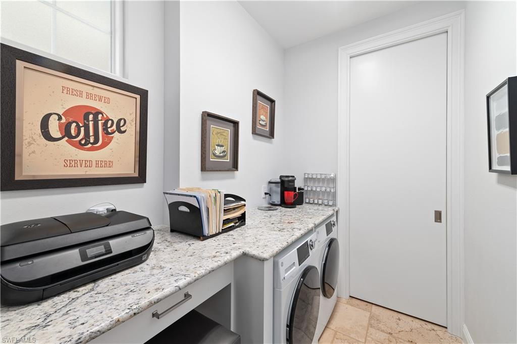 21490 Strada Nuova Circle, Unit D211 Estero, FL 33928 - Photo 27 of 45 a view of a kitchen with fridge and wooden floor