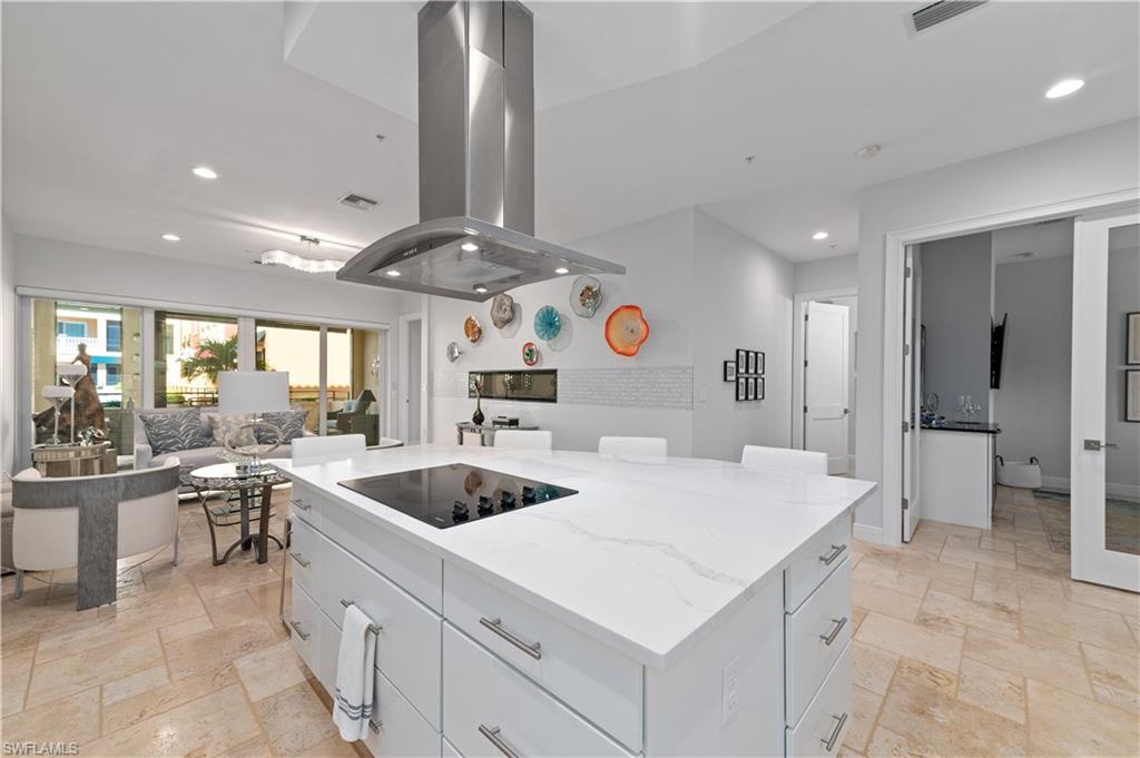 21490 Strada Nuova Circle, Unit D211 Estero, FL 33928 - Photo 3 of 45 a kitchen with a sink and chairs