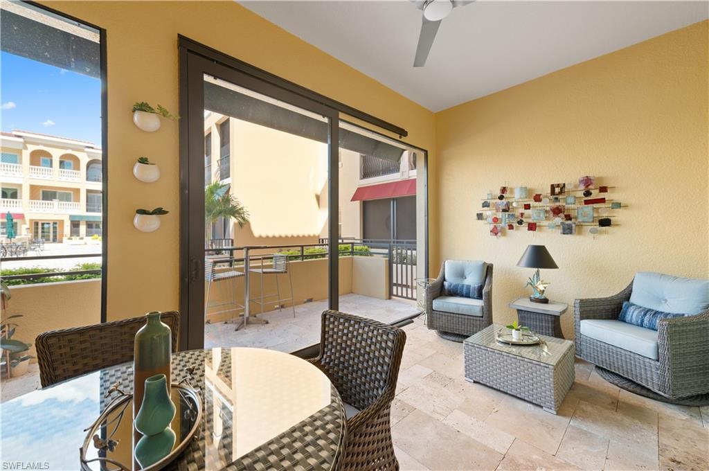21490 Strada Nuova Circle, Unit D211 Estero, FL 33928 - Photo 31 of 45 a living room with furniture and a large window