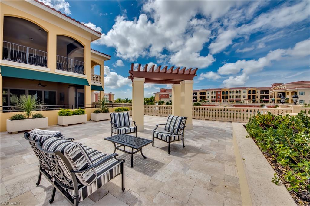 21490 Strada Nuova Circle, Unit D211 Estero, FL 33928 - Photo 34 of 45 a view of a swimming pool with outdoor seating