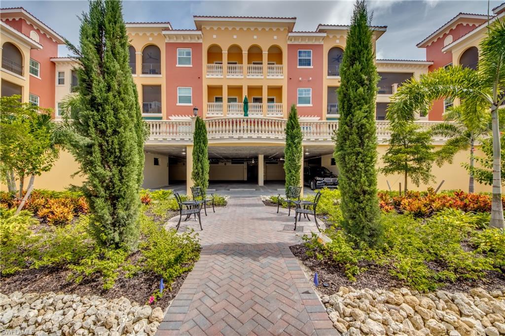 21490 Strada Nuova Circle, Unit D211 Estero, FL 33928 - Photo 35 of 45 a front view of a house with a garden