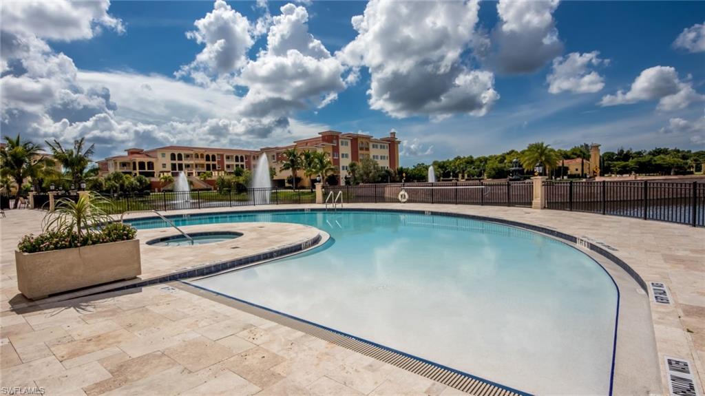 21490 Strada Nuova Circle, Unit D211 Estero, FL 33928 - Photo 36 of 45 a view of a swimming pool with a chair and a potted plant