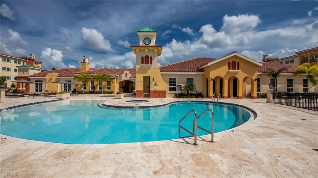 21490 Strada Nuova Circle, Unit D211 Estero, FL 33928 - Photo 40 of 45 a swimming pool with outdoor seating
