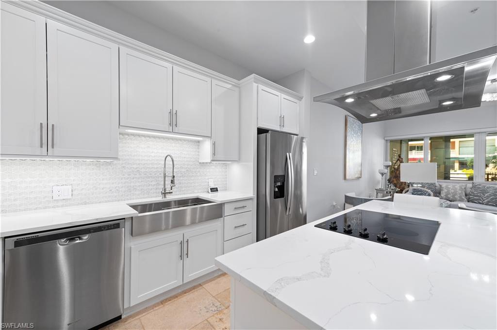 21490 Strada Nuova Circle, Unit D211 Estero, FL 33928 - Photo 5 of 45 a kitchen with a sink a stove and refrigerator