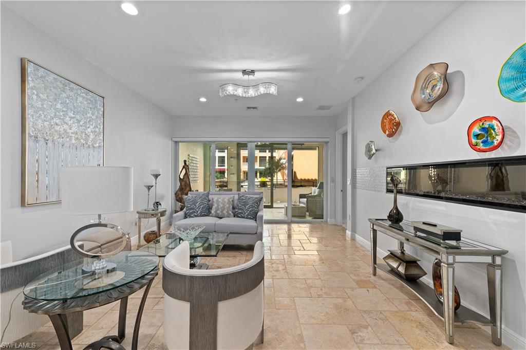 21490 Strada Nuova Circle, Unit D211 Estero, FL 33928 - Photo 10 of 45 a living room with furniture and a flat screen tv