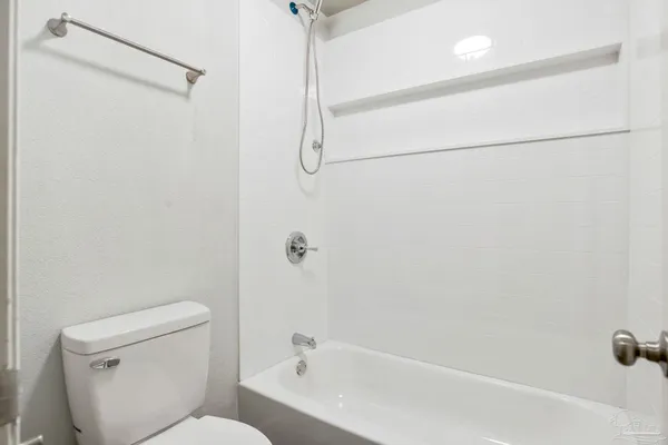 a bathroom with a toilet and a bathtub