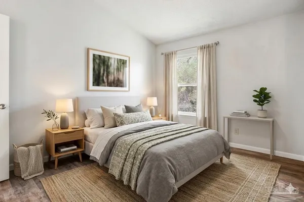 a bedroom with a bed and a potted plant