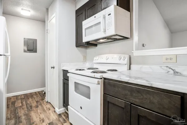 a kitchen with stainless steel appliances granite countertop a sink and a stove