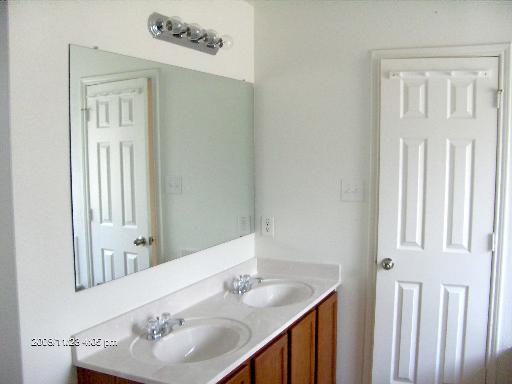 13202 Baldwin Ridge San Antonio, TX 78249 - Photo 13 of 20 a bathroom with a sink vanity and a mirror