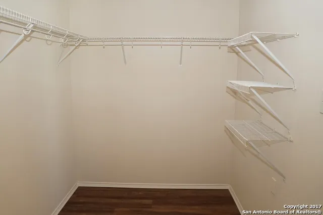 a view of a room with wooden floor and a window