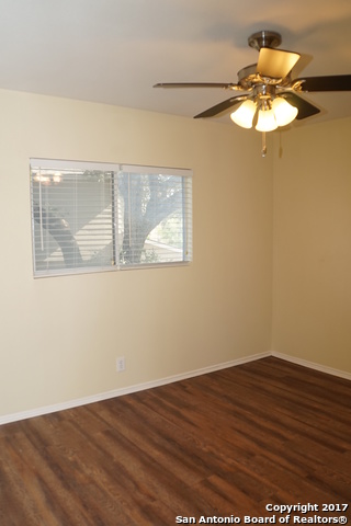 13202 Baldwin Ridge San Antonio, TX 78249 - Photo 17 of 20 an empty room with wooden floor and windows