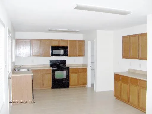 a kitchen with stainless steel appliances granite countertop a stove and a refrigerator