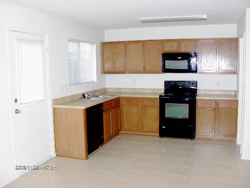 13202 Baldwin Ridge San Antonio, TX 78249 - Photo 7 of 20 a kitchen with a refrigerator stove and microwave
