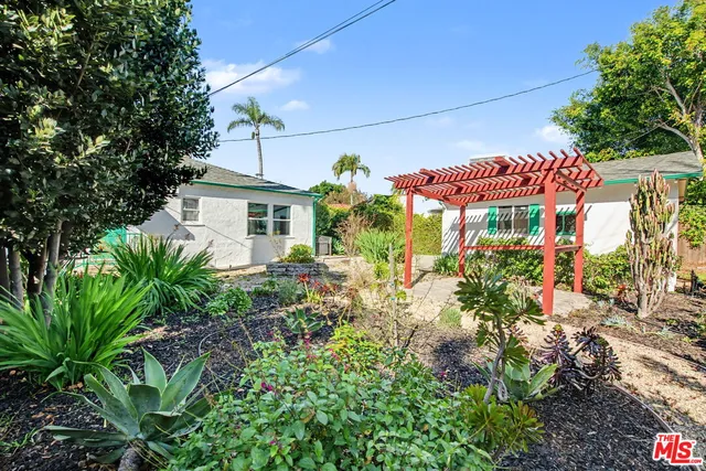 a front view of a house with plants