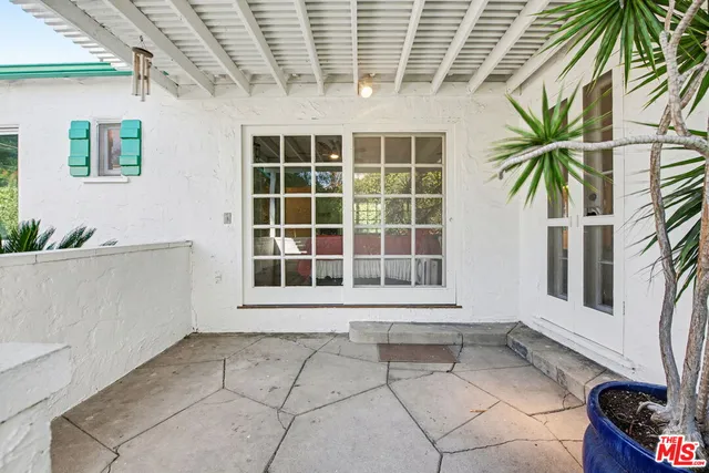 a view of a house with a potted plant and a window