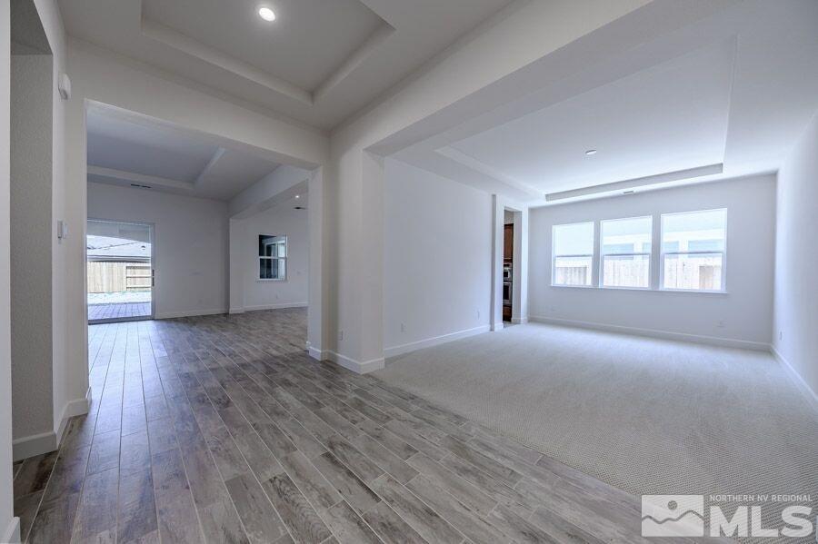 2345 Stone Rise Road, Unit SORRENTO TRAIL LOT #132 Reno, NV 89521 - Photo 3 of 11 a view of an empty room with wooden floor and a window