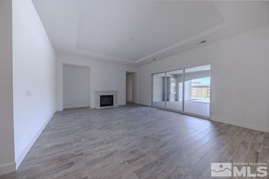 2345 Stone Rise Road, Unit SORRENTO TRAIL LOT #132 Reno, NV 89521 - Photo 4 of 11 a view of an empty room with wooden floor and a window