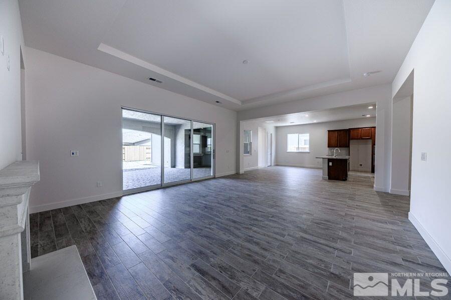 2345 Stone Rise Road, Unit SORRENTO TRAIL LOT #132 Reno, NV 89521 - Photo 5 of 11 a view of empty room with a fireplace and wooden floor