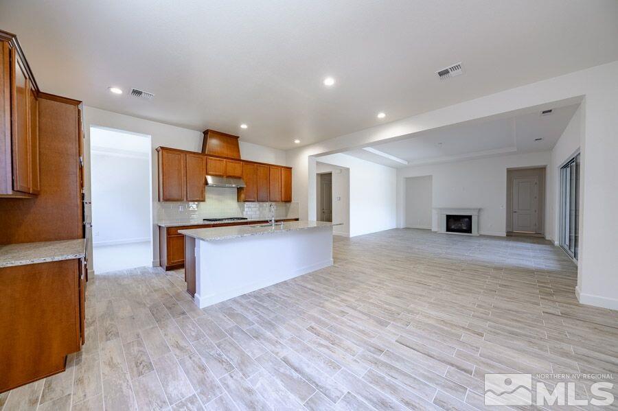 2345 Stone Rise Road, Unit SORRENTO TRAIL LOT #132 Reno, NV 89521 - Photo 7 of 11 a large kitchen with stainless steel appliances kitchen island a large counter top and a stove top oven
