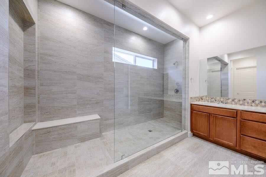 2345 Stone Rise Road, Unit SORRENTO TRAIL LOT #132 Reno, NV 89521 - Photo 8 of 11 a bathroom with a bathtub and a shower