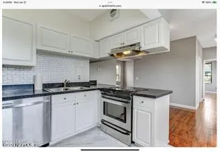 a bathroom with a bathtub sink and mirror