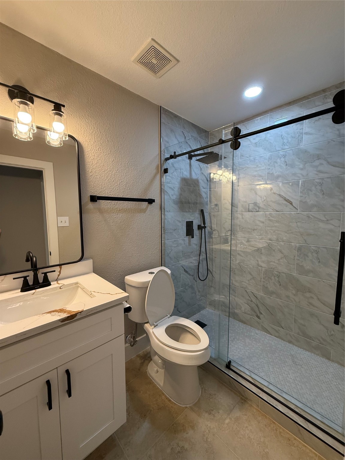 3819 Banks Ridge Lane Katy, TX 77449 - Photo 12 of 19 a bathroom with a granite countertop sink toilet a mirror and shower