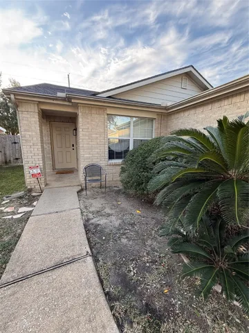 a view of a house with a small yard and plants