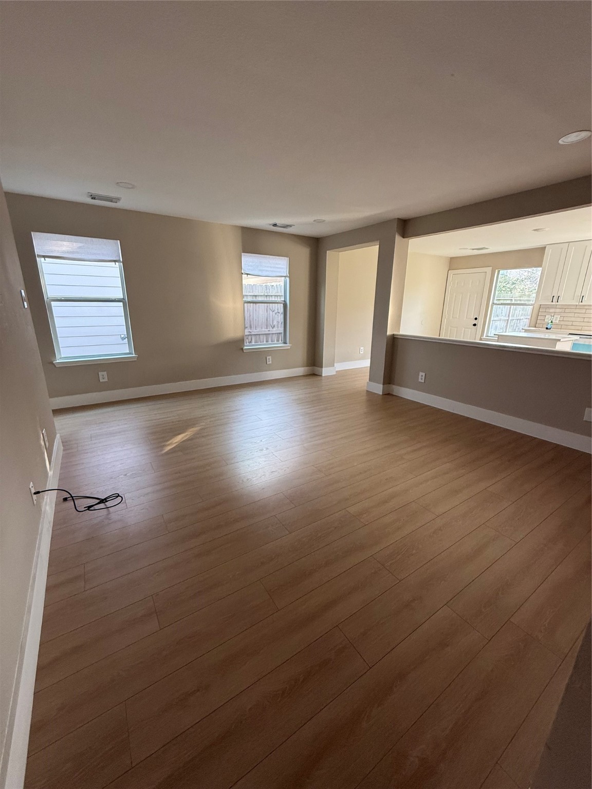 3819 Banks Ridge Lane Katy, TX 77449 - Photo 7 of 19 an empty room with wooden floor and windows