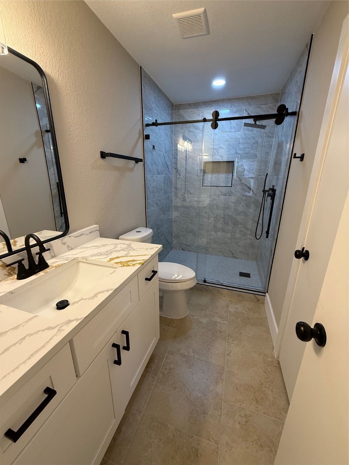3819 Banks Ridge Lane Katy, TX 77449 - Photo 10 of 19 a bathroom with a granite countertop sink toilet and shower