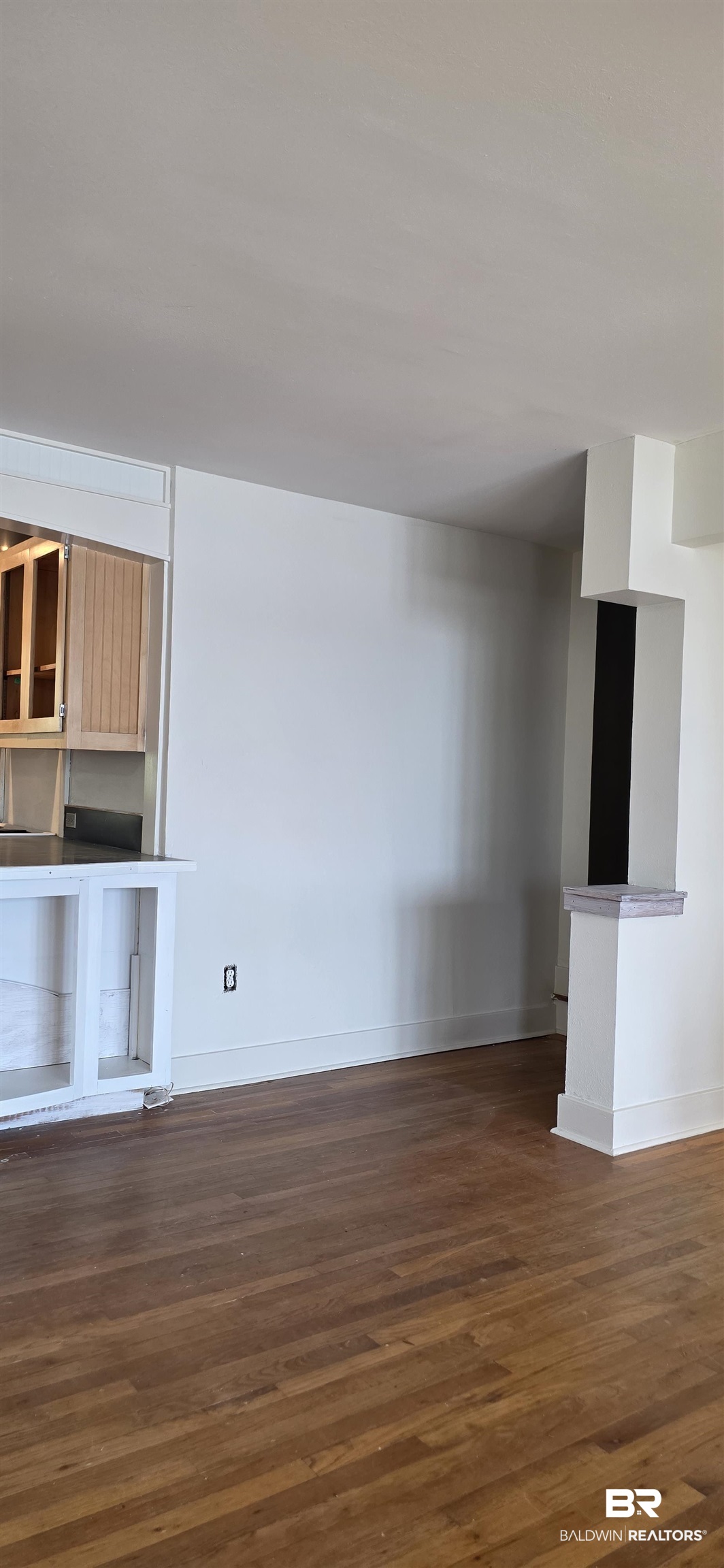 544 Windmill Ridge Road Gulf Shores, AL 36542 - Photo 23 of 50 Unfurnished living room with dark wood finished floors and baseboards