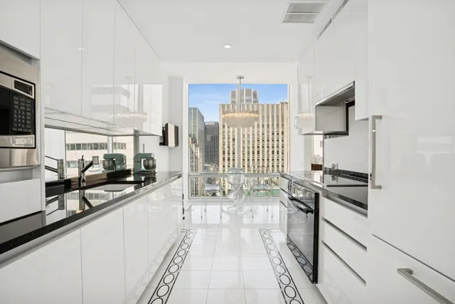 a kitchen with stainless steel appliances a sink stove and cabinets