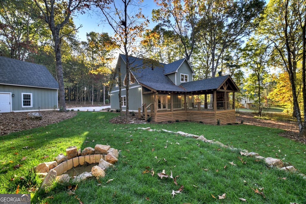 646 High Country Crossing Morganton, GA 30560 - Photo 12 of 44 a view of a house with a yard swing and a tree
