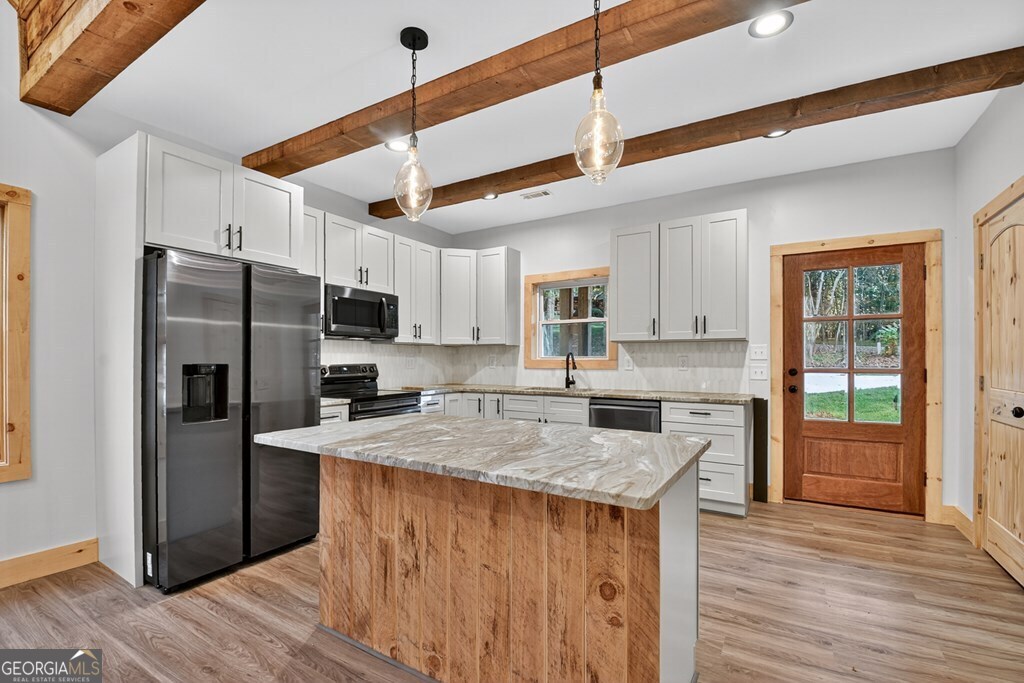 646 High Country Crossing Morganton, GA 30560 - Photo 22 of 44 a kitchen with stainless steel appliances granite countertop a refrigerator a sink dishwasher a stove and a refrigerator with wooden floor