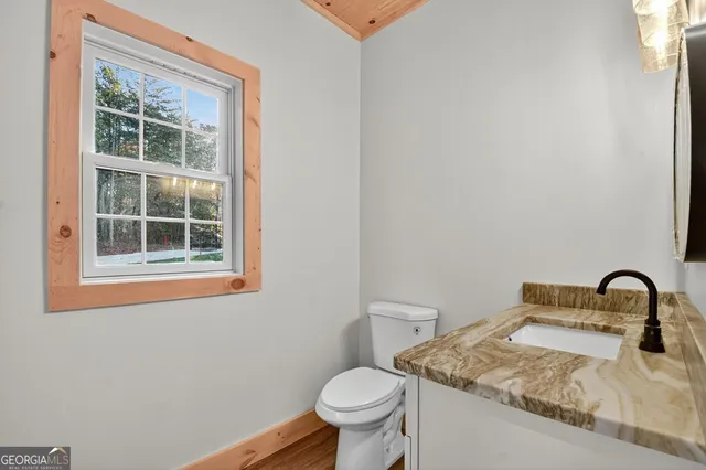 a bathroom with a toilet sink and mirror