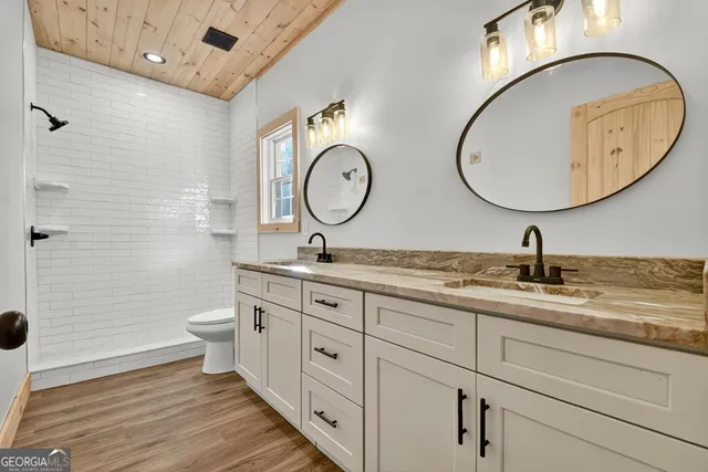 a bathroom with a double vanity sink and a mirror
