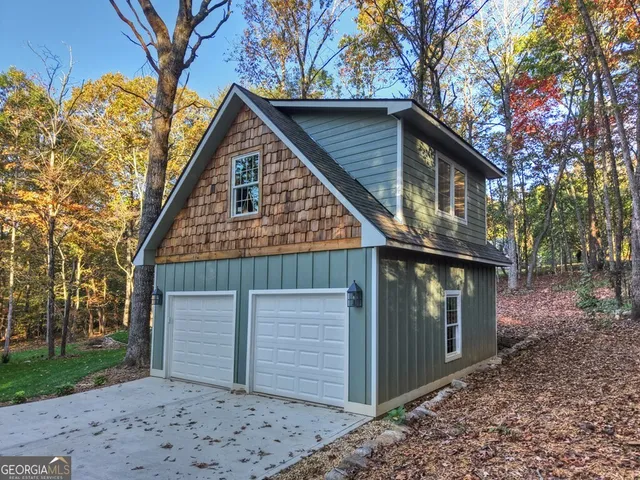 a view of house with a large tree