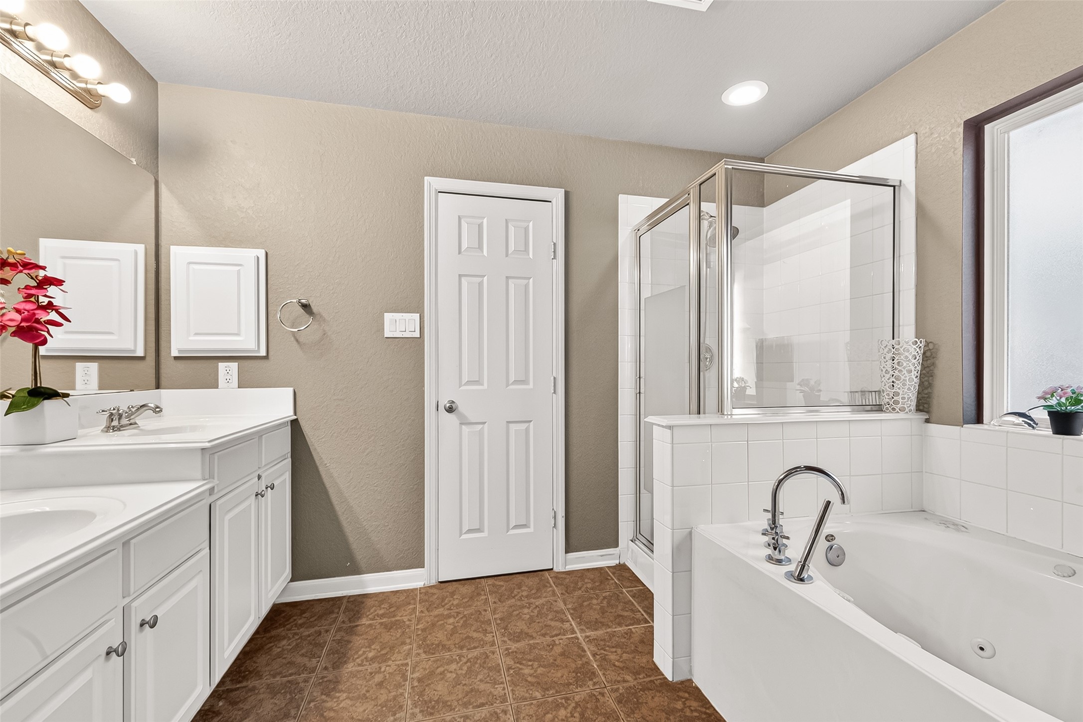 16715 Mackenzie Mesa Drive Spring, TX 77379 - Photo 38 of 50 a bathroom with a bathtub sink vanity and mirror