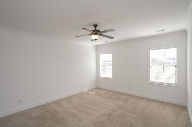 an empty room with a window and a ceiling fan