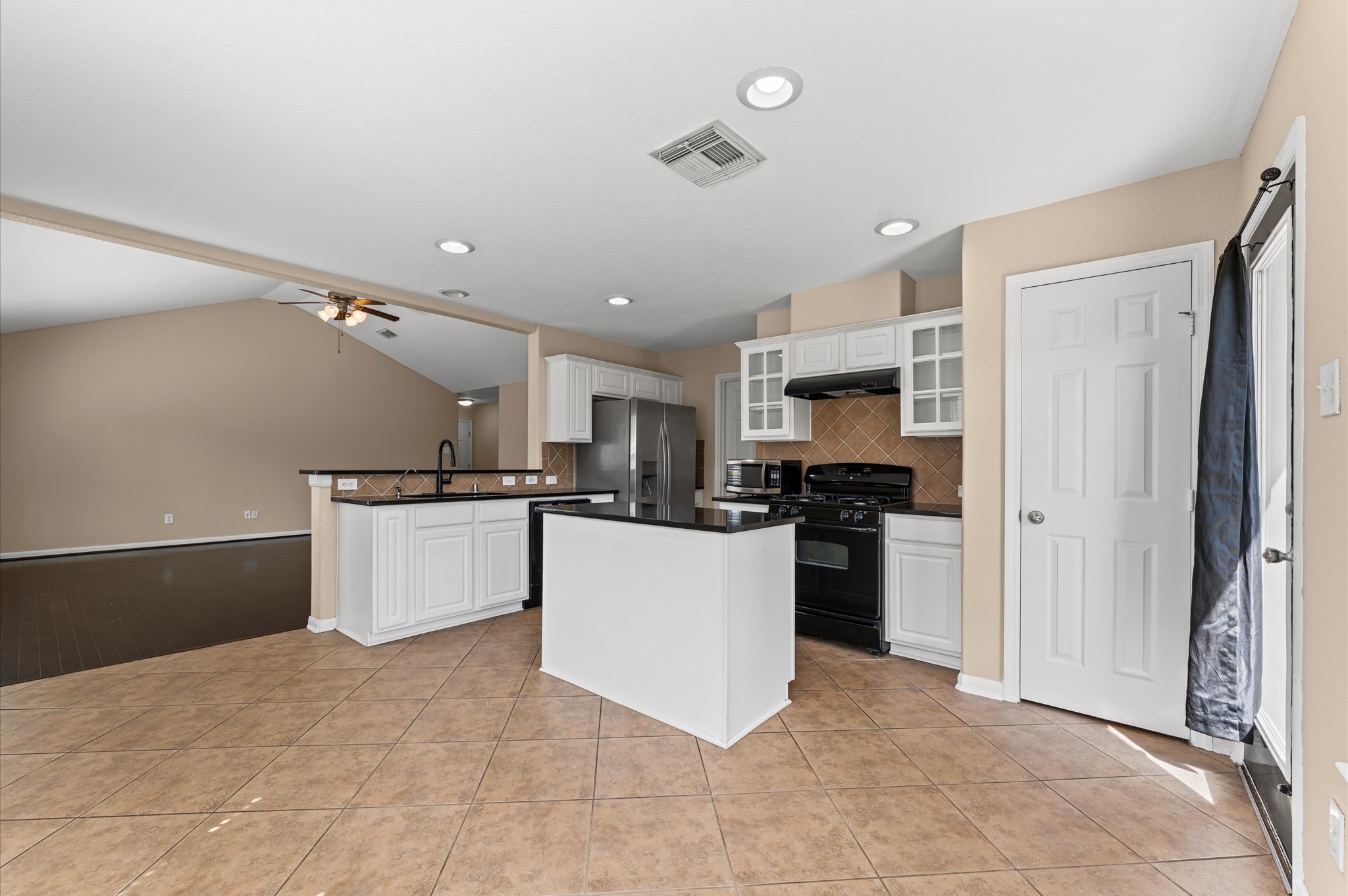 3010 Pathfinders Pass Spring, TX 77373 - Photo 13 of 26 a large kitchen with cabinets and stainless steel appliances
