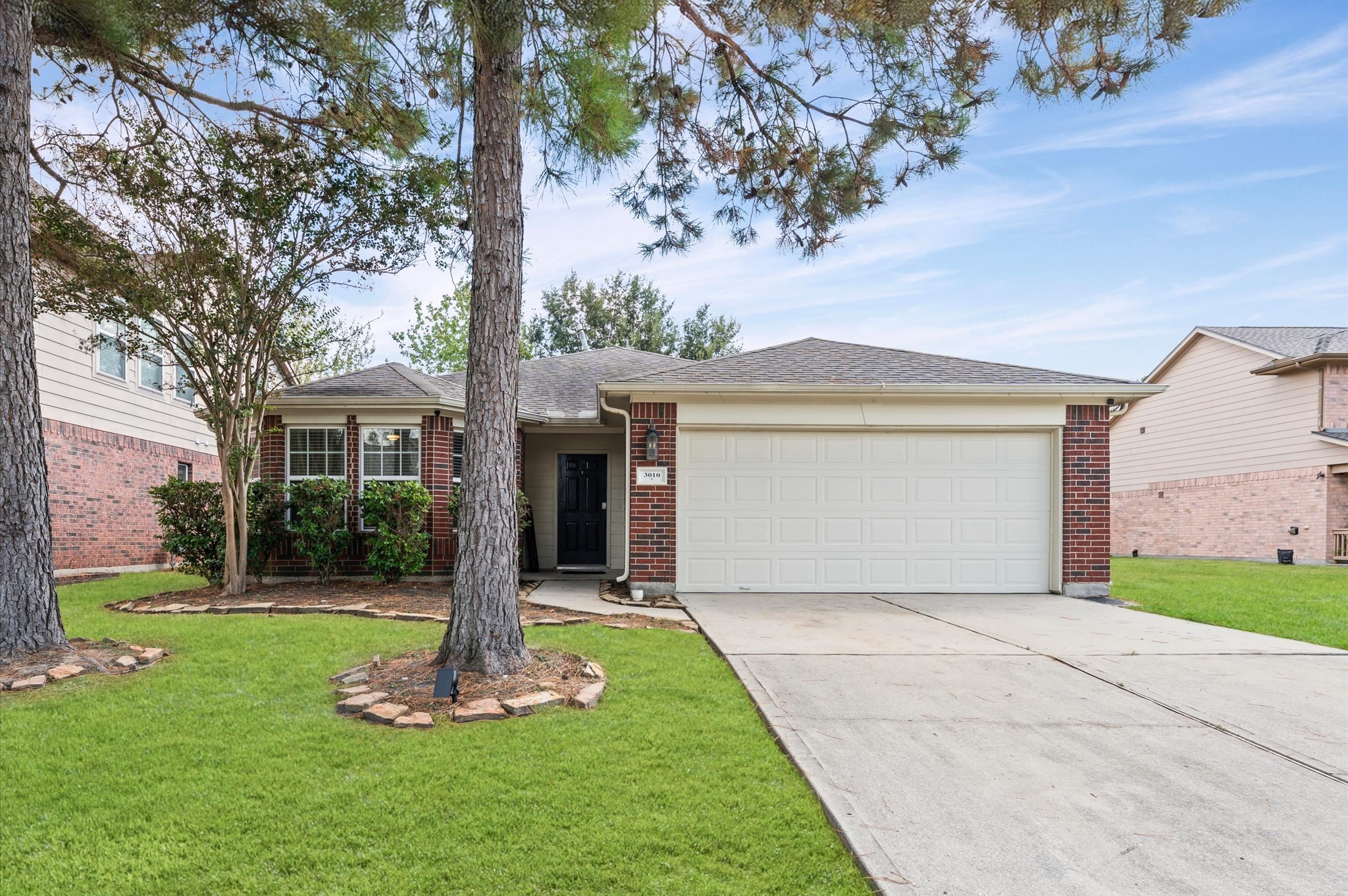 3010 Pathfinders Pass Spring, TX 77373 - Photo 2 of 26 a front view of a house with a yard and garage