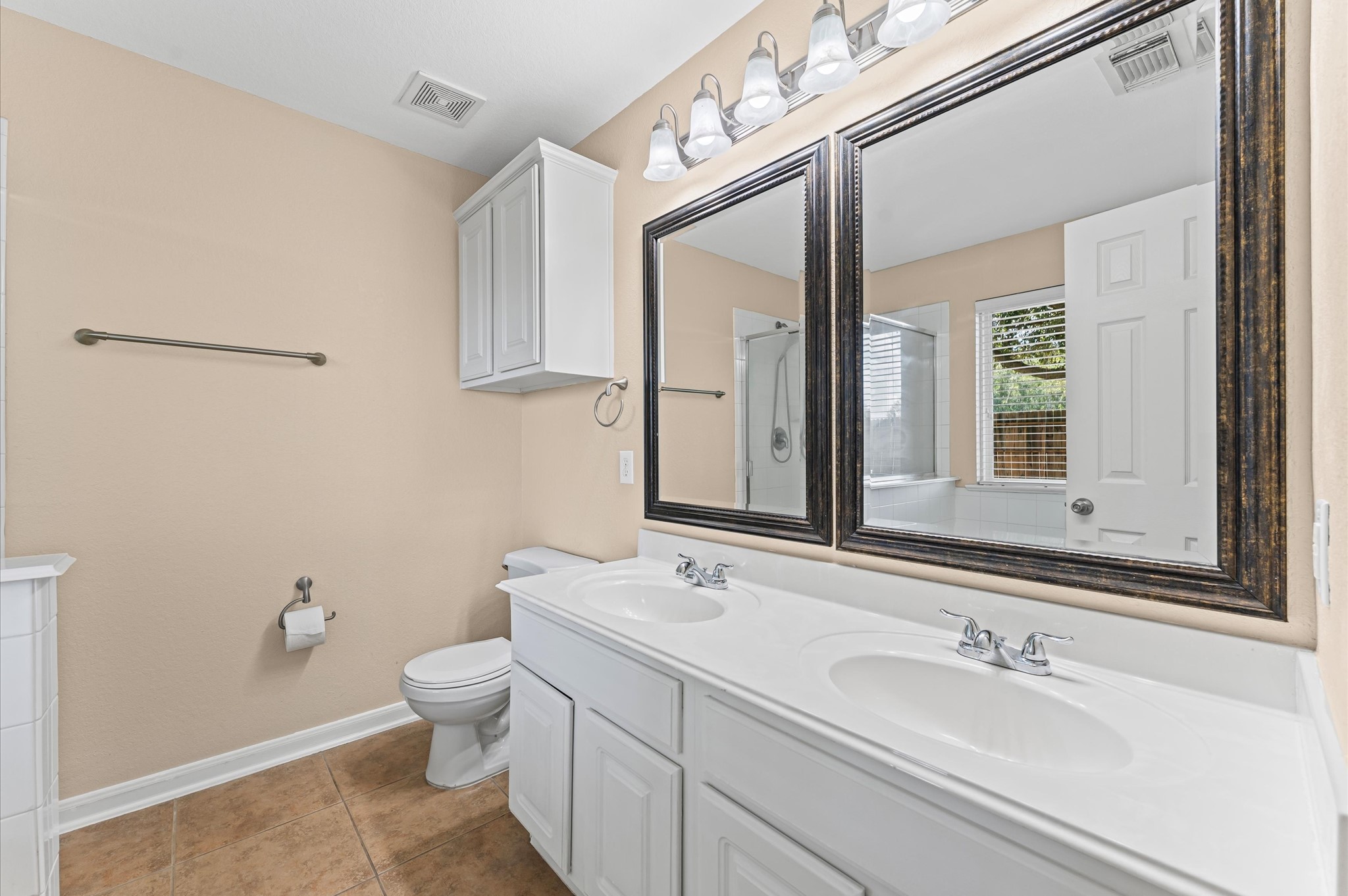 3010 Pathfinders Pass Spring, TX 77373 - Photo 21 of 26 a bathroom with a toilet a sink and mirror