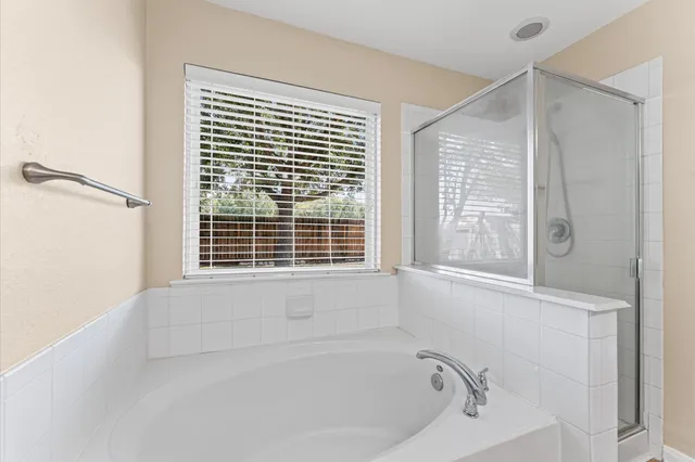 a white bath tub sitting next to a window