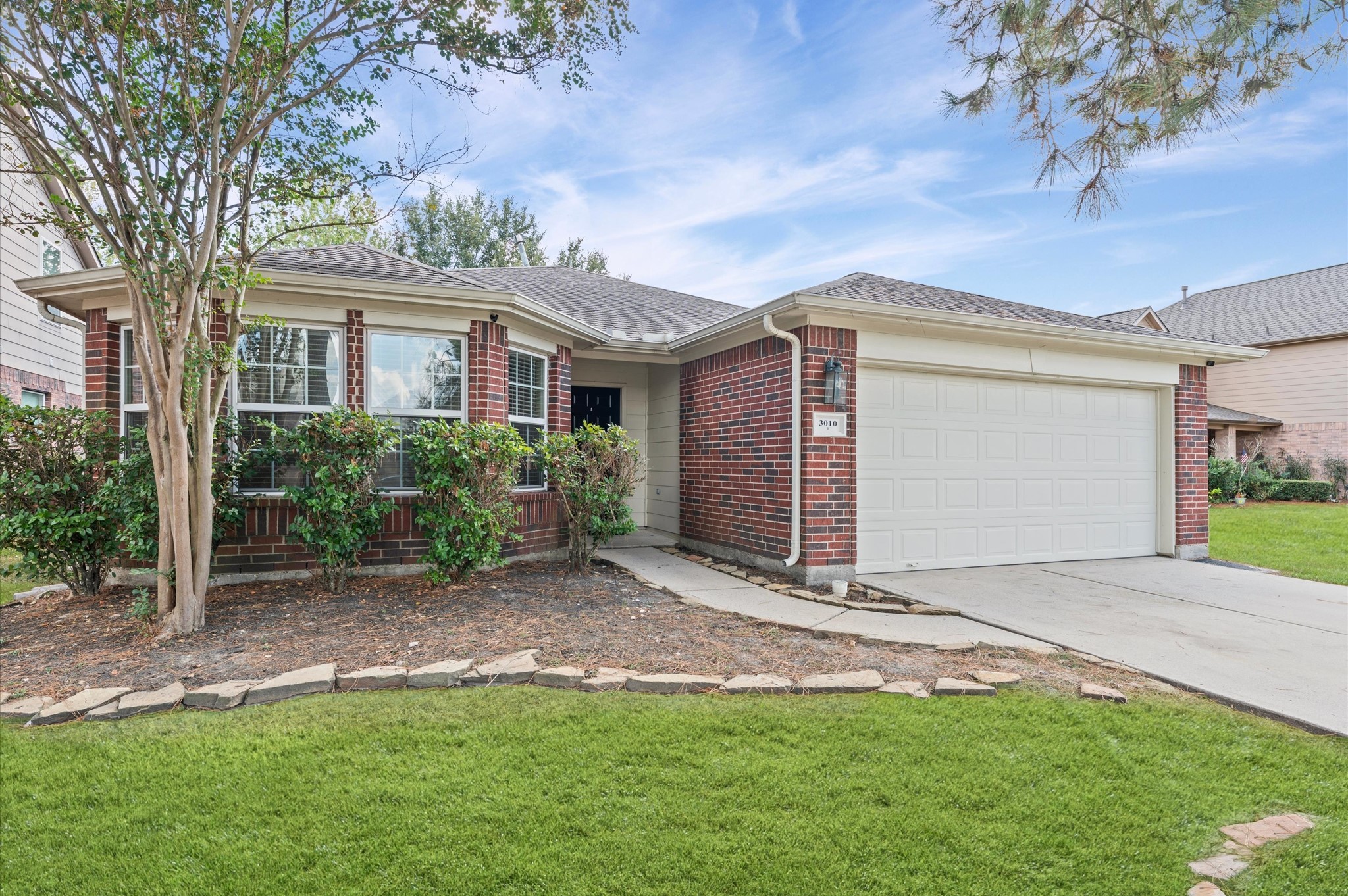 3010 Pathfinders Pass Spring, TX 77373 - Photo 4 of 26 a front view of a house with a garden and yard